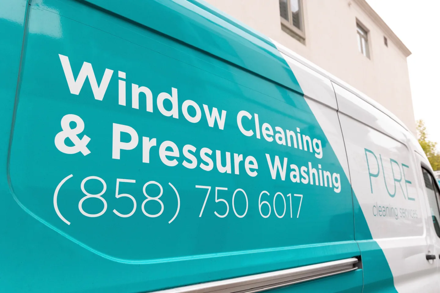 Pure Cleaning Services van with window cleaning and pressure washing branding