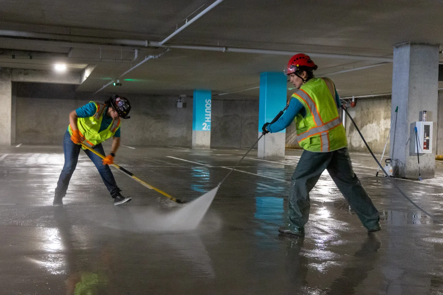 PCS crew pressure washing a commercial parking garage