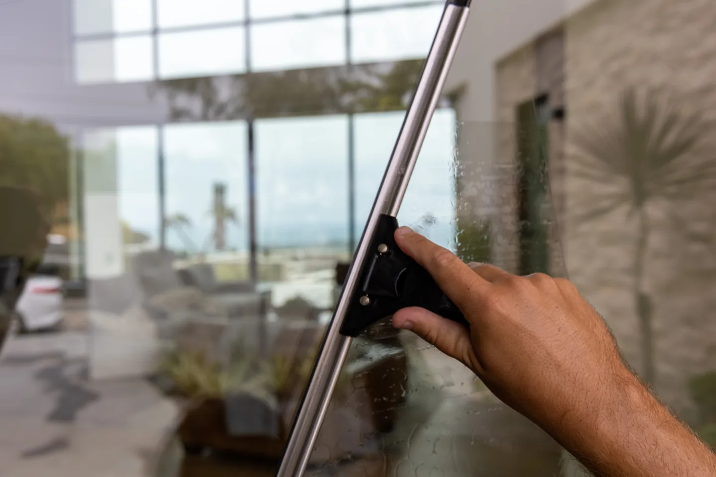 Close-up of a PCS technician detailing interior window glass