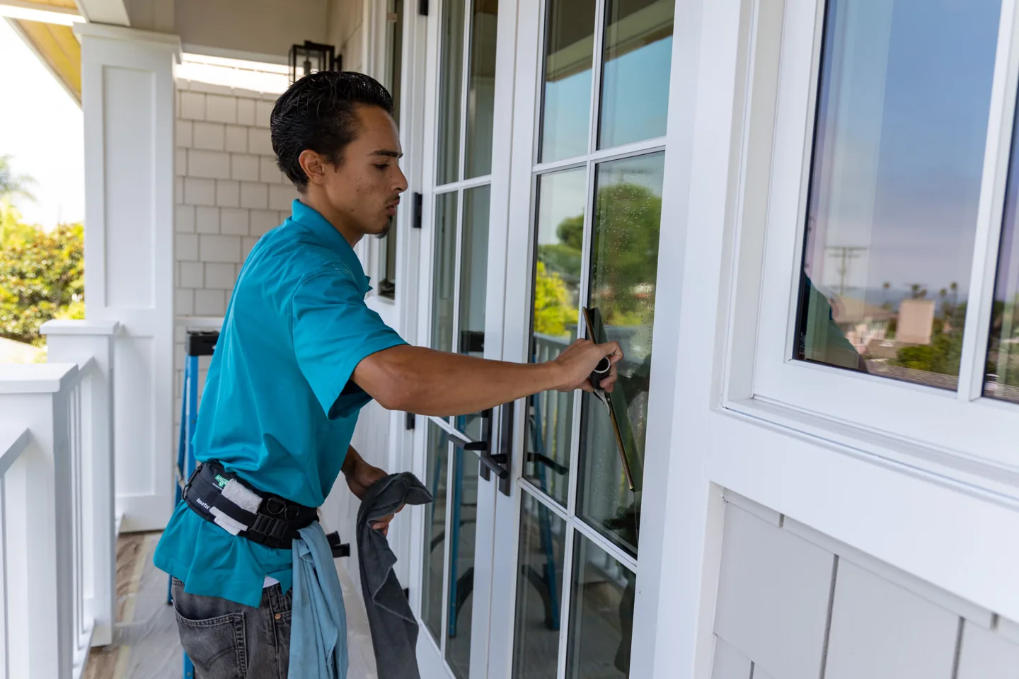 PCS technician detailing a home's window glass