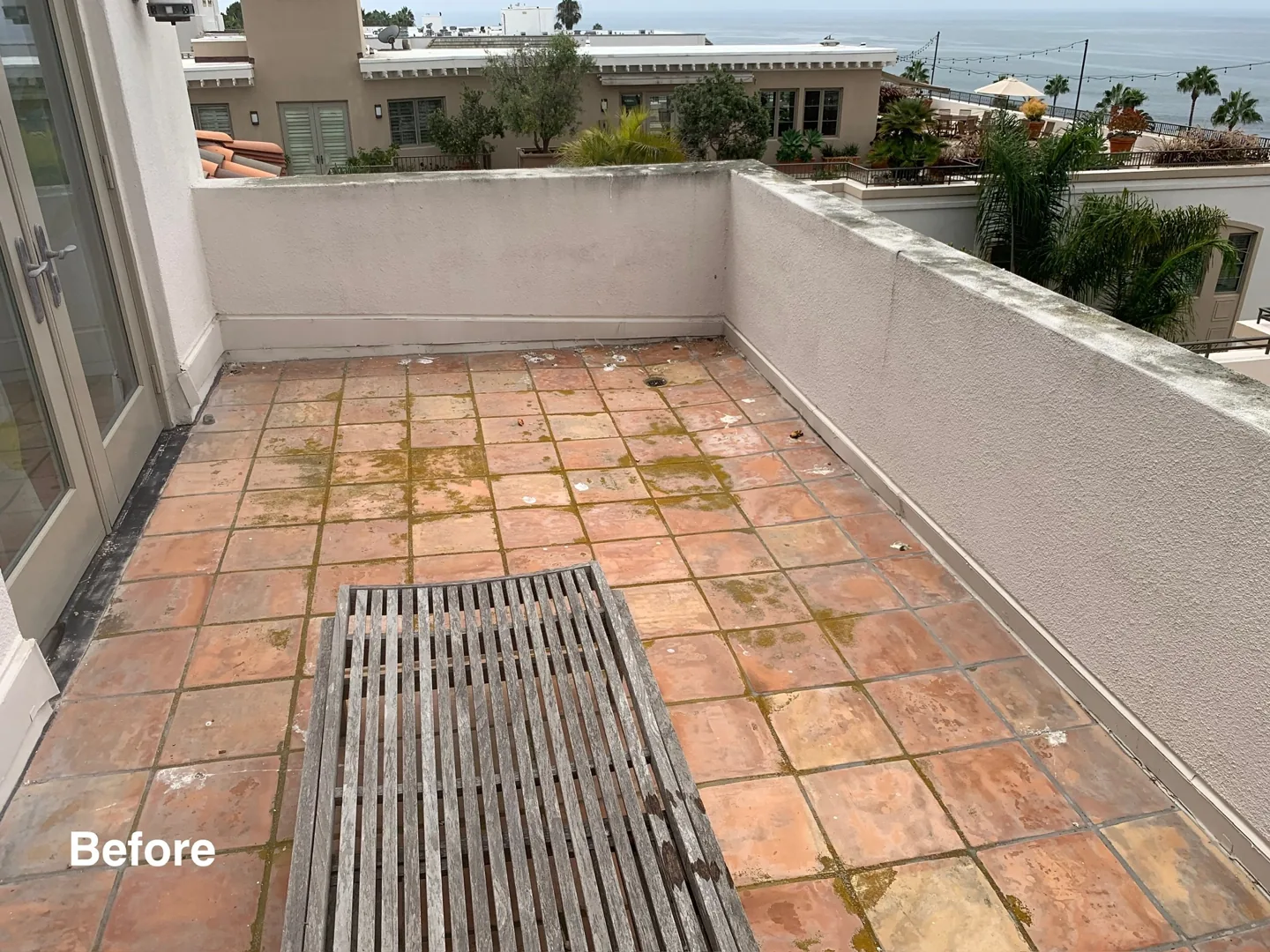 Tiled patio with surface buildup before PCS cleaning