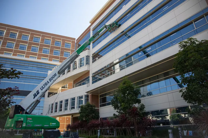 Commercial office building with a lift positioned for exterior window cleaning