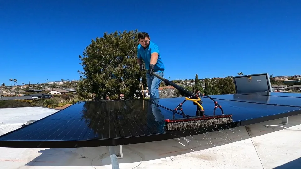 PCS technician cleaning a residential solar panel array